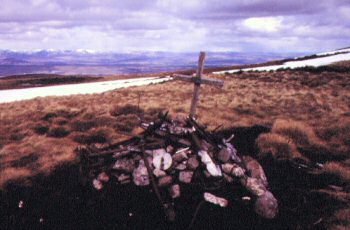 Small pile of wreckage and memorial cross