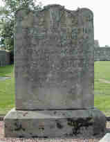 Two heads and a hand, shown at the top of their grave stone.